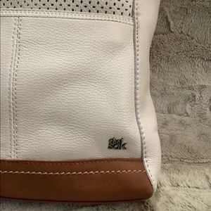 The Sak cream and tan pebbled leather messenger